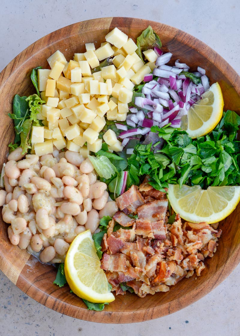 This easy White Bean Salad is packed with crispy bacon, salty gouda cheese, and a refreshing lemon vinaigrette.