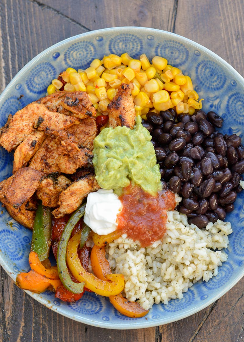 This Chicken Burrito Bowl is filled with fajita chicken, veggies and protein packed beans! This is the perfect recipe for meal prep or a busy weeknight that your whole family will love!